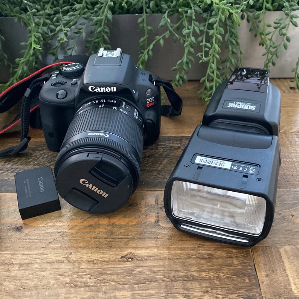 Canon EOS Rebel SL1 camera with box and flash